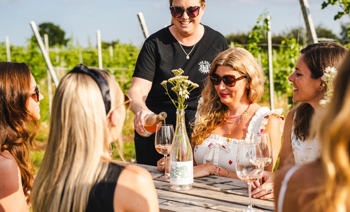 A group of friends tasting welsh wine